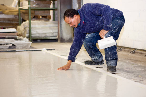 Wear and tear on a garage floor coating from tool impacts.