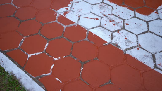 Worn garage floor coating showing uneven appearance over time