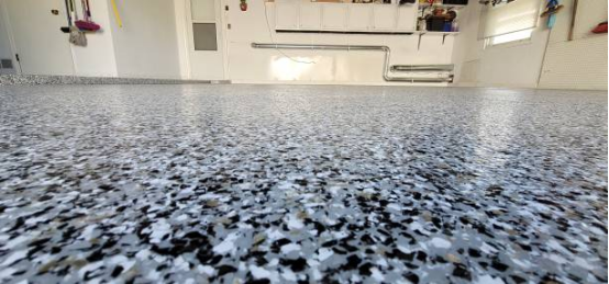 Family DIY project applying Garage Floor Coating in a home garage