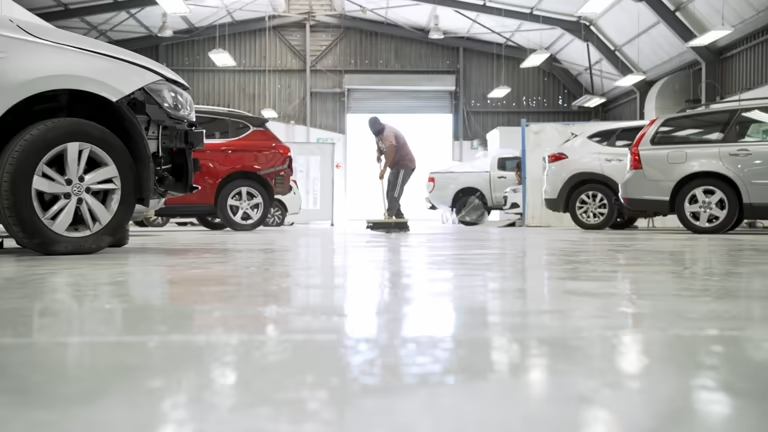 Professional cleaning prepares for garage floor coating application.