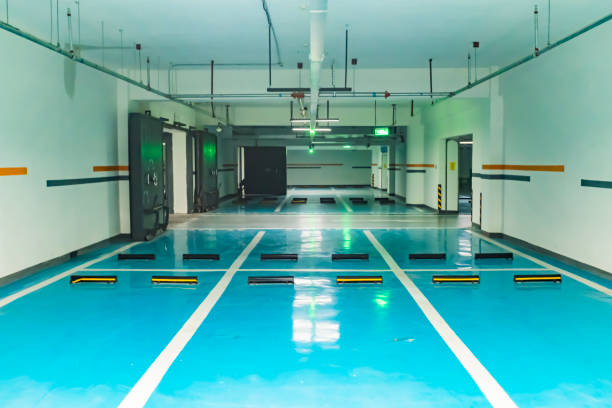 Vibrant blue garage floor coating shines in this clean, empty parking facility.