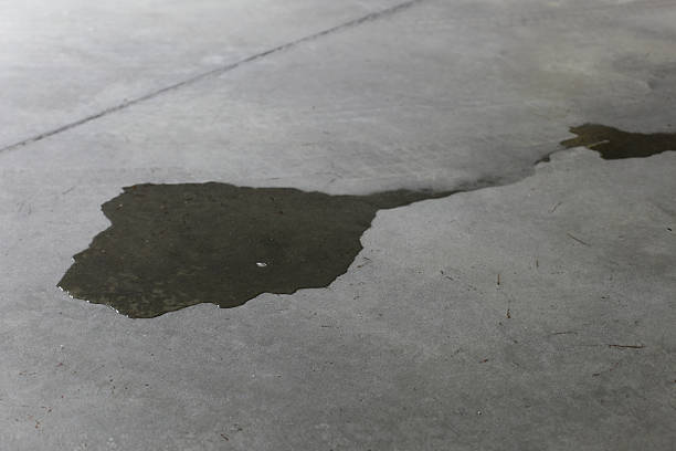 Garage floor coating does not fix all problems. 3 Liquid spill on bare concrete floor, highlighting need for protective garage floor coating.