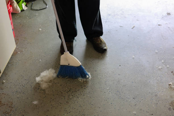 Sweeping dust and debris before garage floor coating.
