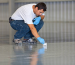 Man inspecting new garage floor coating application.