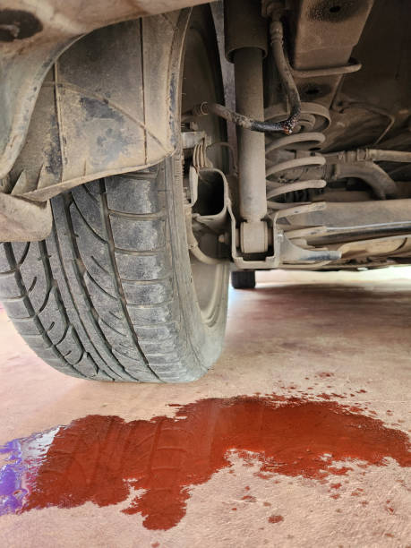 Car leak on concrete floor highlights need for protective garage floor coating.