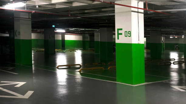 Underground parking garage with green pillars and durable grey garage floor coating, ready for vehicles.