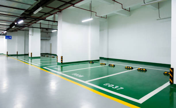 Modern garage with green and grey garage floor coating and painted parking spots.