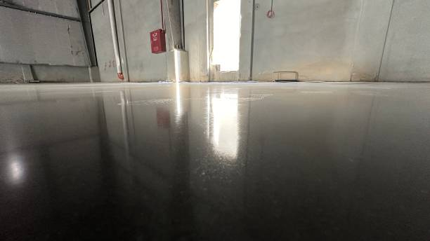 Stunning, highly reflective black Garage Floor Coating in a large, industrial space.