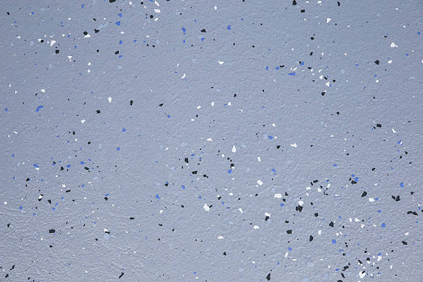 Detailed speckled blue, black, white garage floor coating texture.