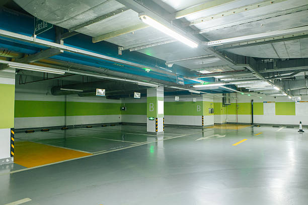 Clean, empty underground garage with striped walls and a smooth, protective garage floor coating.