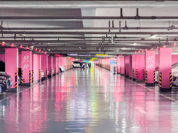 Modern underground parking garage featuring a vibrant pink and reflective Garage Floor Coating.