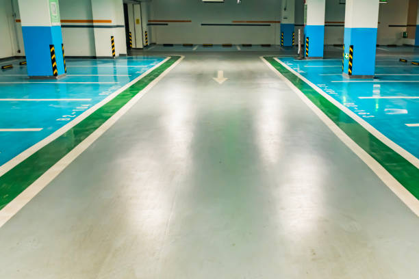 Bright underground parking garage featuring a durable, multi-colored garage floor coating with clear lines.